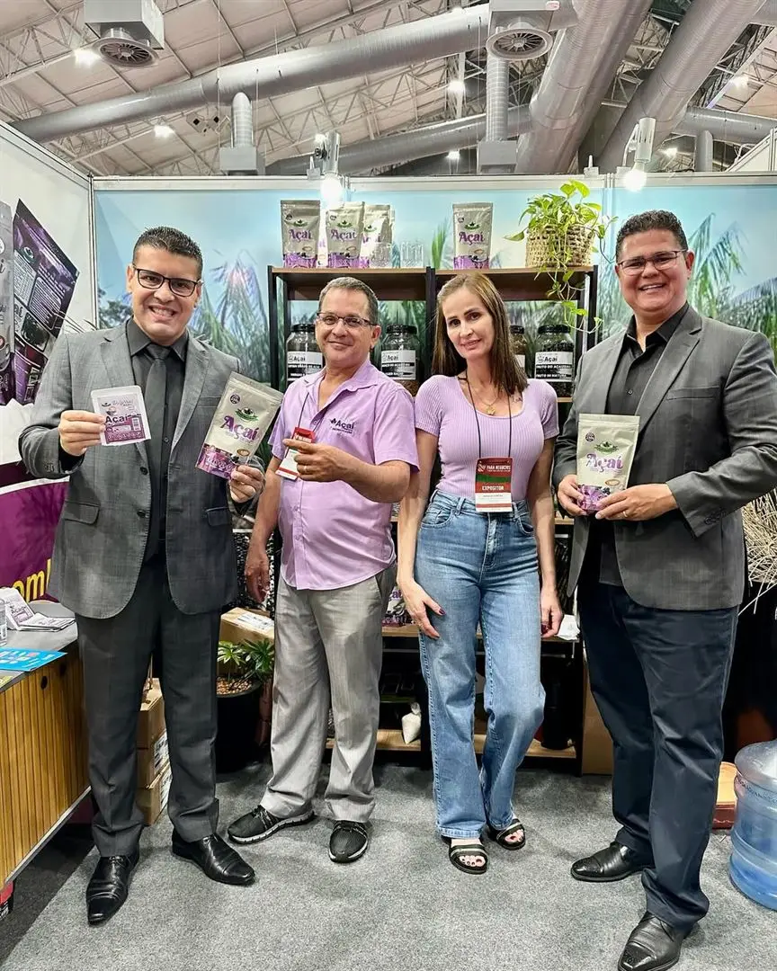 The Brazil's Natural Secret stand at a trade fair, with pouches and jars on a retail shelf.