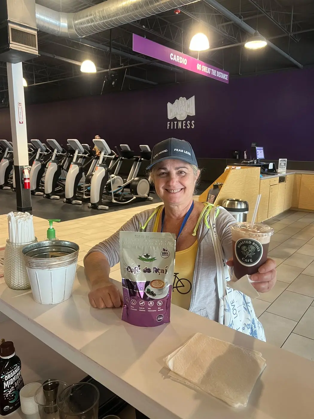 A 250 g pouch of Café de Açaí on the counter of a US café, beside a cup of the brewed drink.