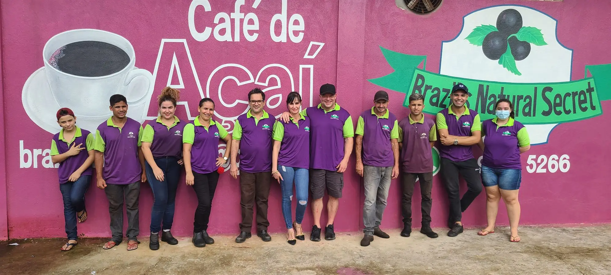 The team who run the Brazil's Natural Secret factory, outside the painted factory wall in Itupiranga.